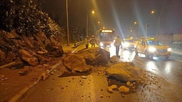 İzmir'de yağmur dolayısıyla koparak yola sakıt kaya parçaları tempo halindeki arabaya dokunca verd